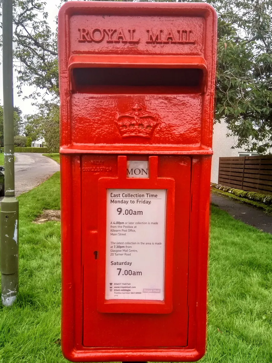 A Royal Mail lamp box with its collection times plate